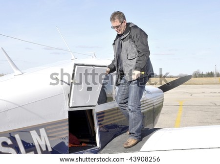 pilot inspecting a small single engine  aircraft
