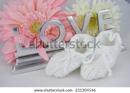 Baby socks with love letters and flowers