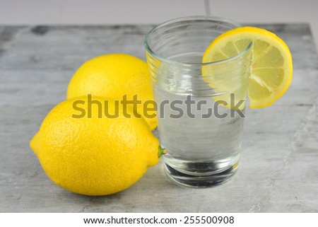 Healthy lemon water on a wooden background