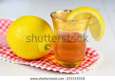Lemon tea in a small tea glass with a slice of lemon