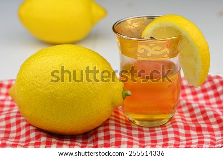Lemon tea in a small tea glass with a slice of lemon