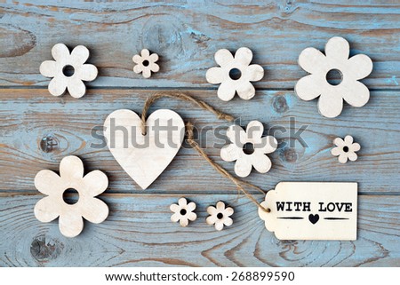 blue grey background with wooden hearts and flower and with love, for you label