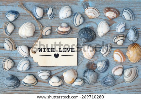blue grey old knotted background with wooden with love label with sea shells
