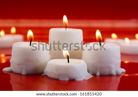 picture of burning candles on red background