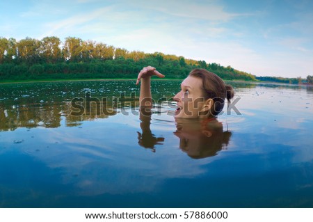 beautiful young girl with a bright emotions swimming in the river