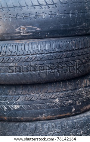Worn tires stacked on each other. Background on the industrial theme.