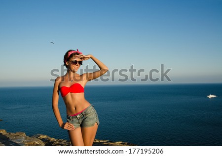slim girl in swimsuit on the background of sky