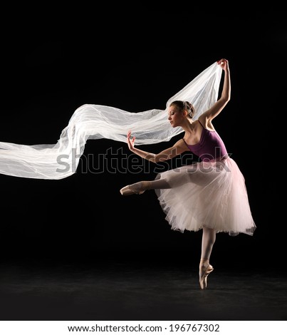 ballet dancer in jump on black background