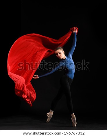 ballet dancer in jump on black background