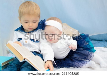 kids reading book in New Year\'s interior in turquoise and white colors