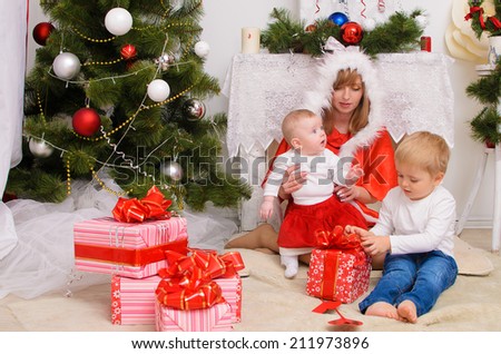 Family in New Year clothes in  room celebrating Christmas