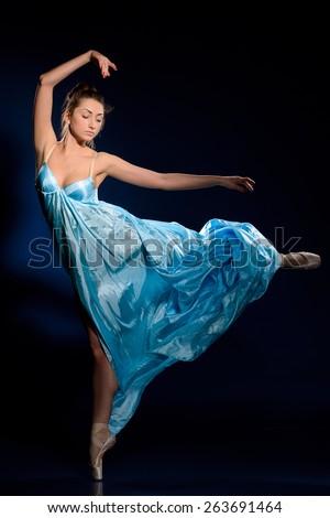 Ballerina jumping, flying in blue dress, studio shooting