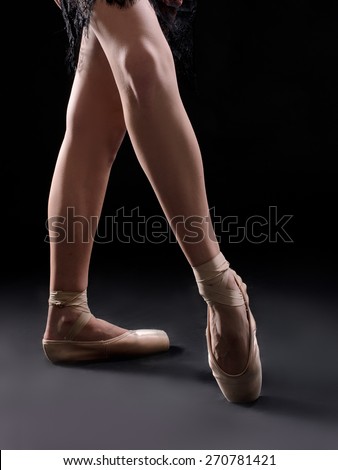 ballet dancer legs pointes on black backgrownd