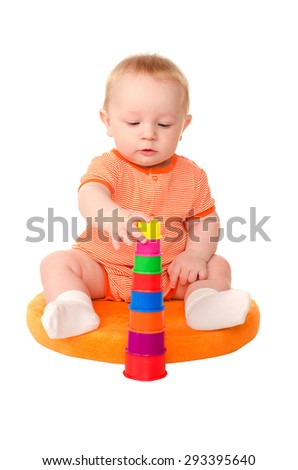 sitting funny baby boy in orange building toy tower isolated on white background