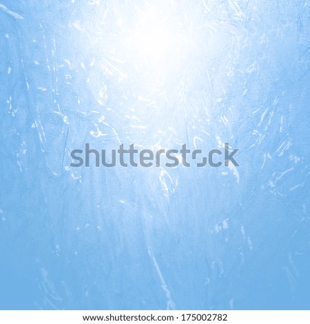 blue abstract background frozen water texture and beam of spot light