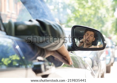 Macro Middle Age Man Reflection on Car Side Mirror. This Man is Stuck at Traffic.