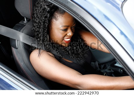 Young Curly Hair Black Woman in Sleeveless Driving a Car in Safety Seat Belt.