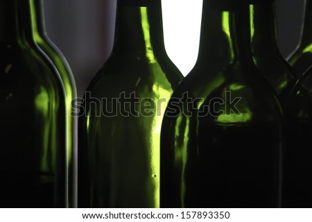 Close up on empty wine bottles without labels.