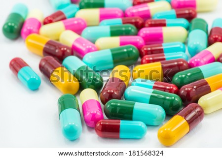 Colorful capsules on white floor.