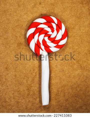 Christmas candy made from modeling clay on brown paper background for Christmas consept