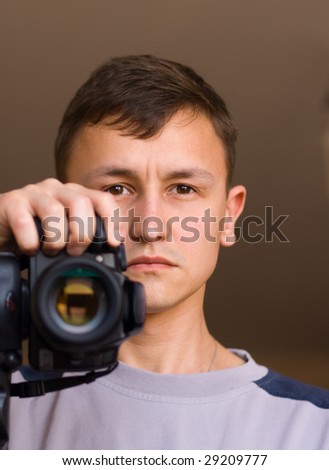 portrait of adult man with black camera