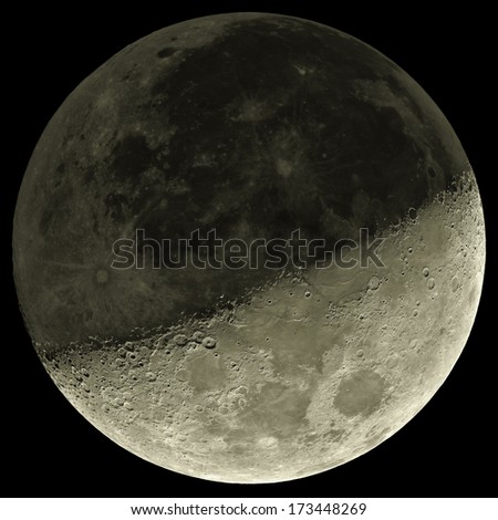 Moon with a shade on a \'darker side\'. Sharp details on the surface.