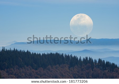 Big Moon rising above the distant mountains. Mosaic photo.