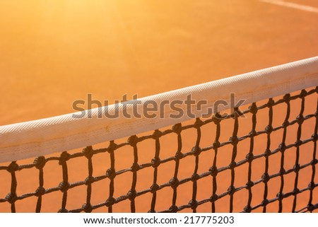 Tennis net with sun flare.
