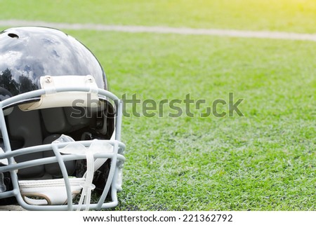 American football helmet on a artificial grass.