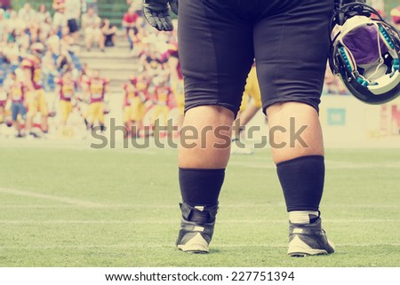 American football - big guy waiting to crush the opposite team.