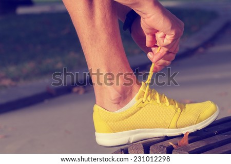 Tying the running shoes.