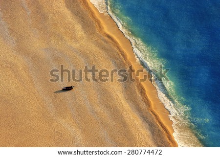 Lonely boat on a beach with aerial view.