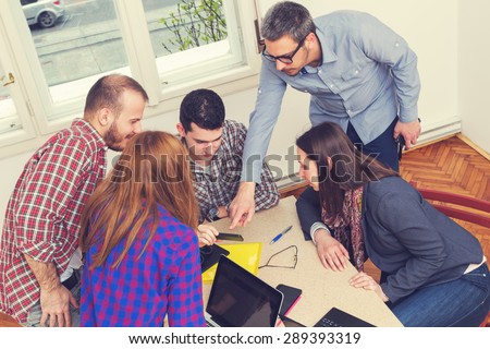 Young group of people discussing business plans.