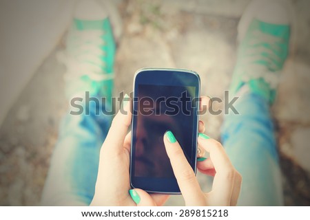 Texting on a smartphone. Shallow depth of field.
