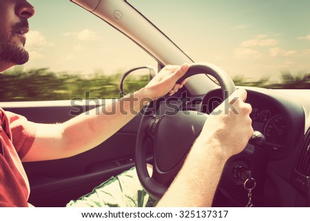 Driving and holding the steering wheel.