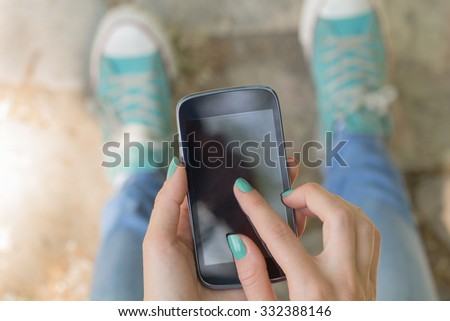 Texting on a smartphone. Shallow depth of field