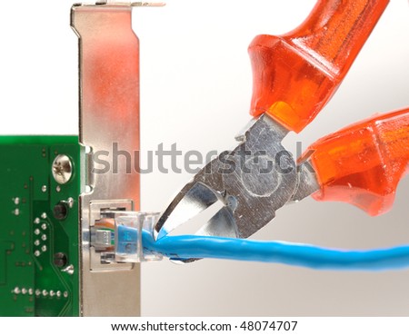 Network cable plugged into network interface card and being cut by pliers, to illustrate connection problems or network security issues.