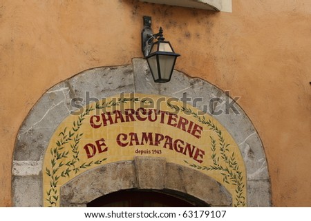 Typical entrance to a butcher\'s shop in southern France. Shop sign made out of several tiles.