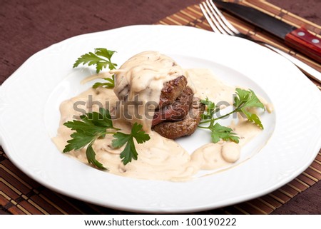 Roasted meat under white sauce