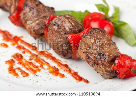 Grilled meat on a white plate