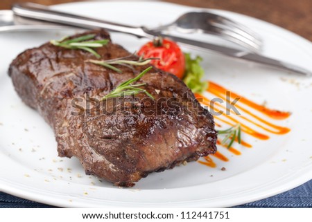 Grilled sirloin steak on a white plate