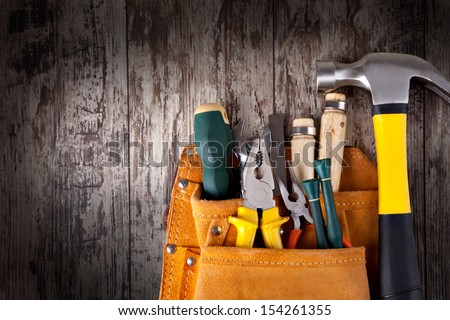 set of tools in tool box on a wooden background