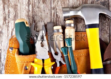 set of tools in tool box on a wooden background