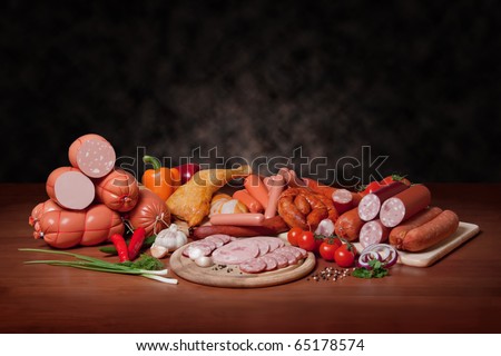 sausage. A variety of processed cold meat products, on a wooden cutting board.