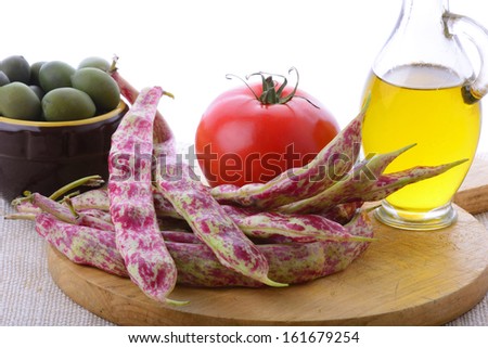 wooden cutting board with vegetables and oil