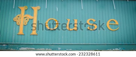 House text on a wooden wall / vintage background