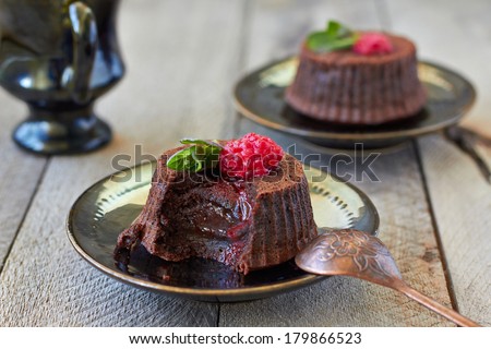 Chocolate fondant lava cake with raspberries and mint