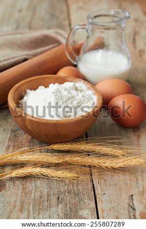Baking ingredients: eggs, milk, flour, rolling pin