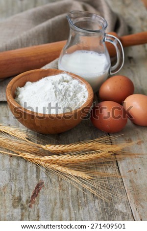 Baking ingredients: eggs, milk, flour, rolling pin