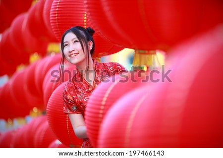 asian beautiful girl in chinese traditional red dress smile in chinese lantern background